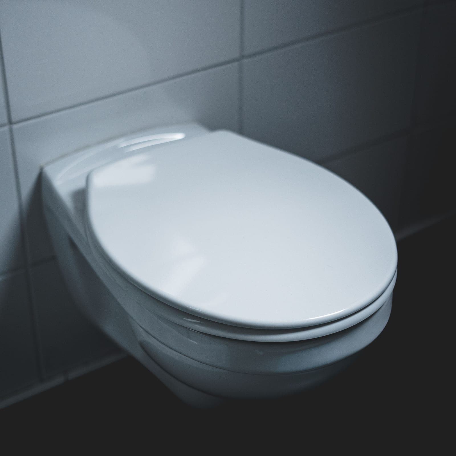 A white toilet seat in a modern bathroom interior