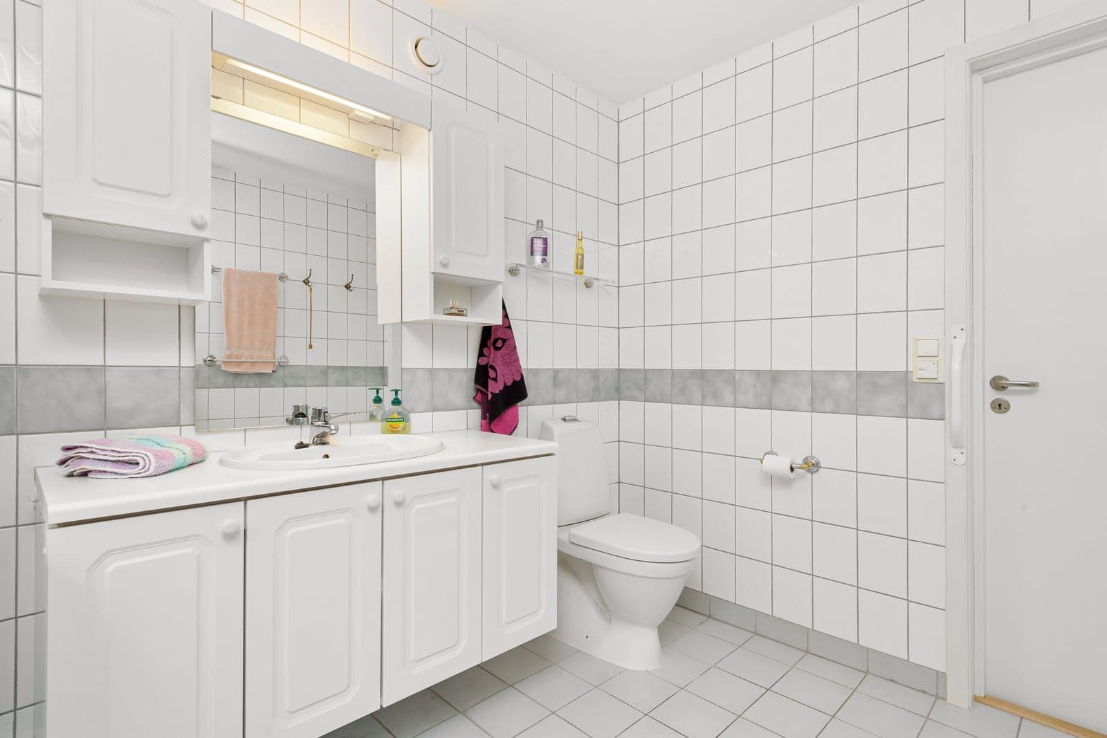 A simple white bathroom with a toilet