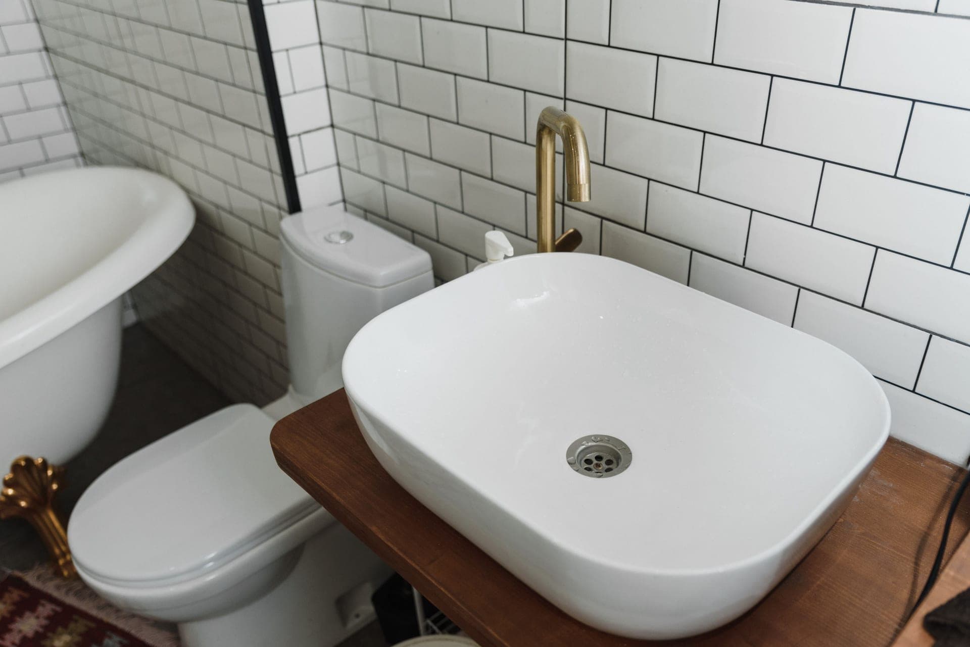 Someone fitting a toilet seat in a bathroom