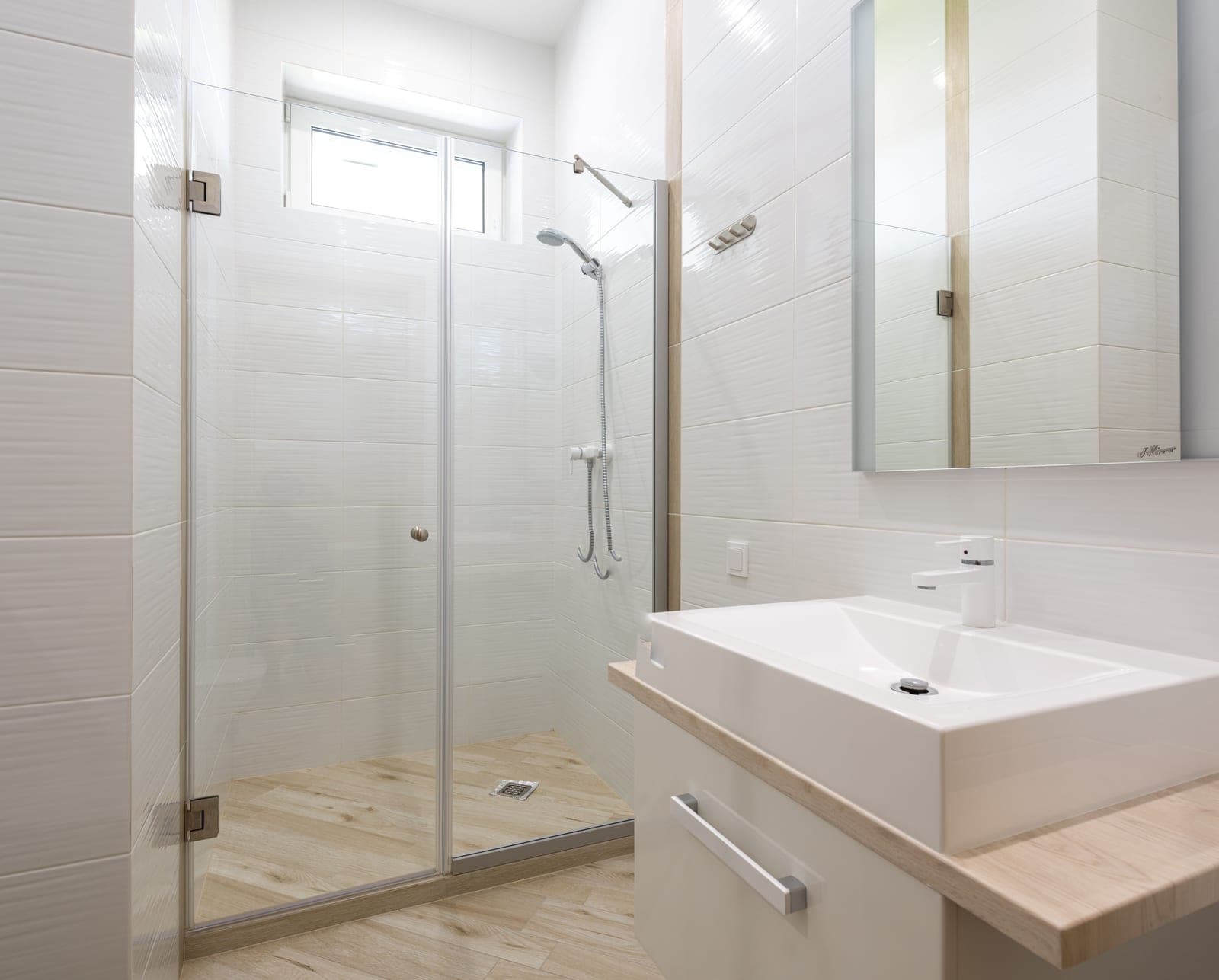 A clean, modern bathroom with white ceramic fittings