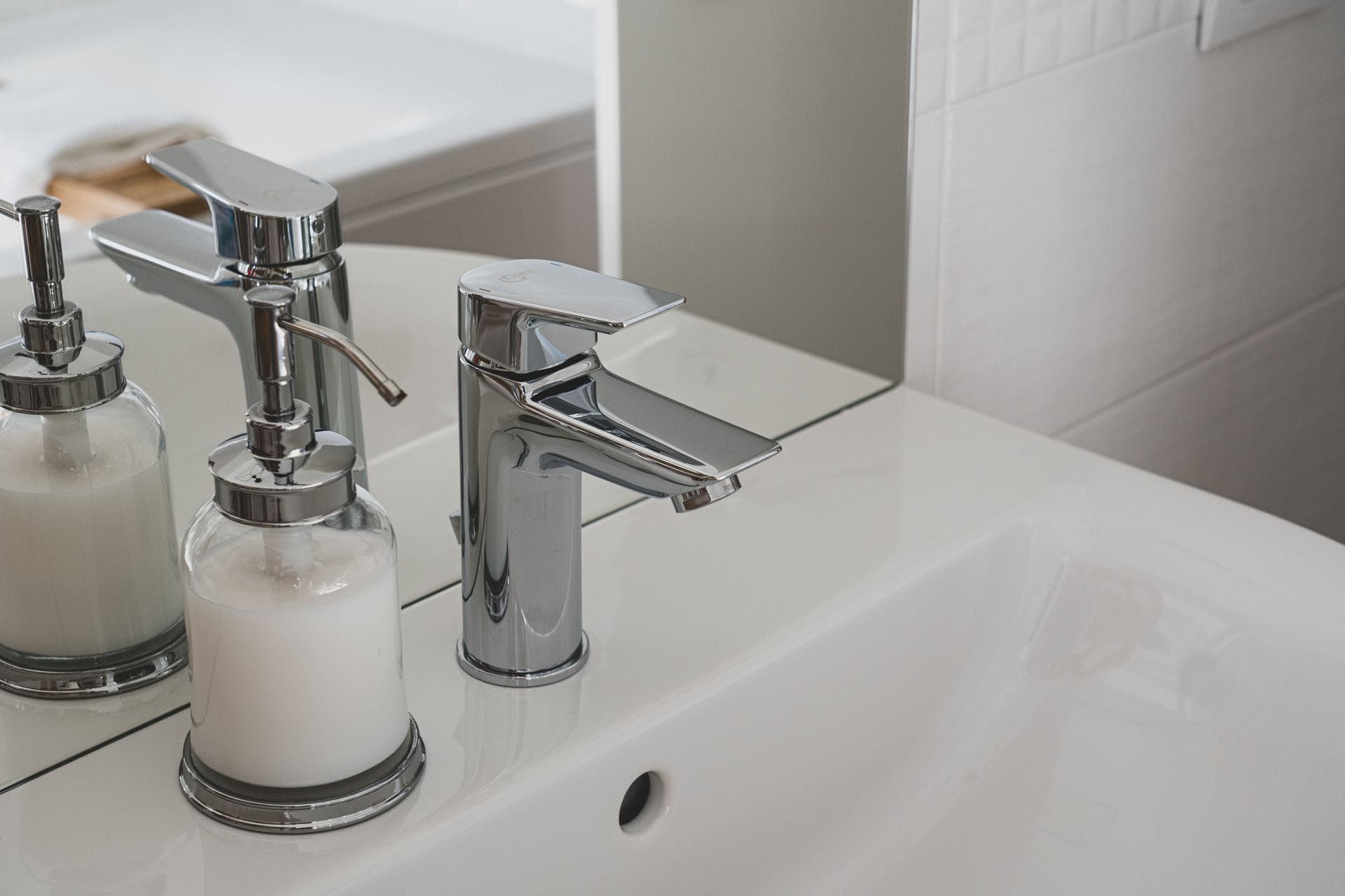 A chrome faucet over a sink