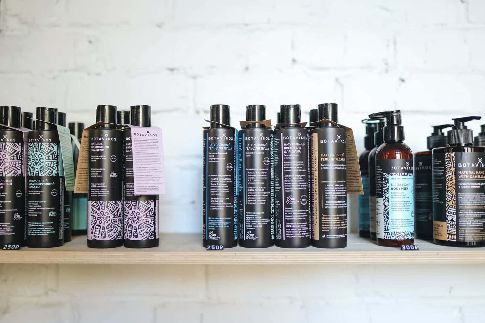 A shelf lined with shampoo and body wash bottles