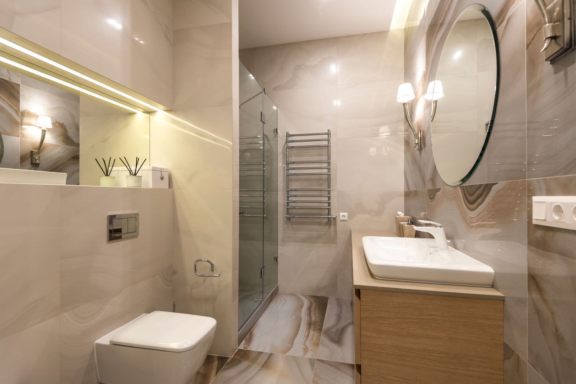 A clear lighted bathroom mirror above a sink