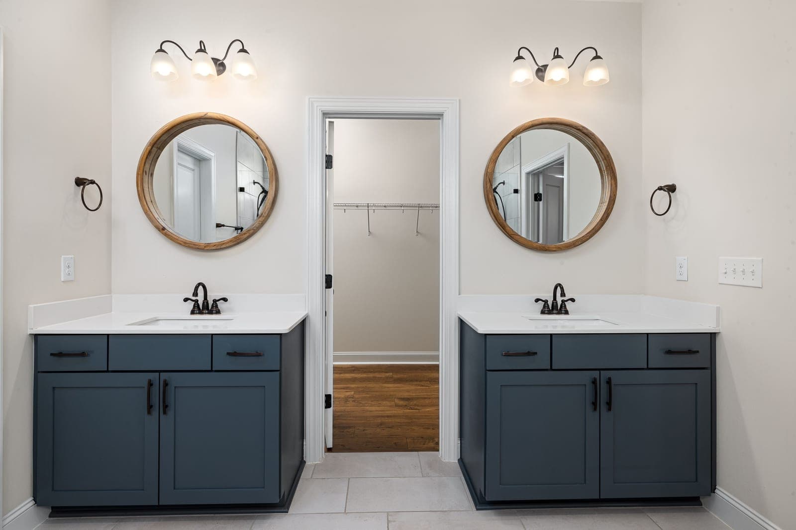 A bathroom vanity with wall lights beside a mirror