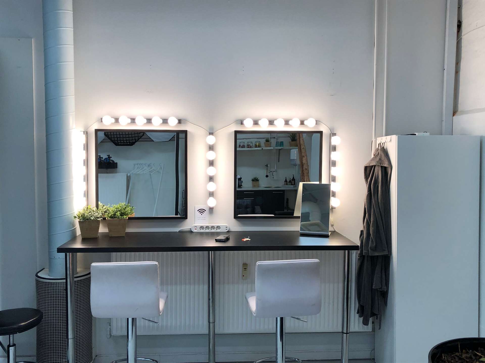 A lighted makeup mirror on a vanity