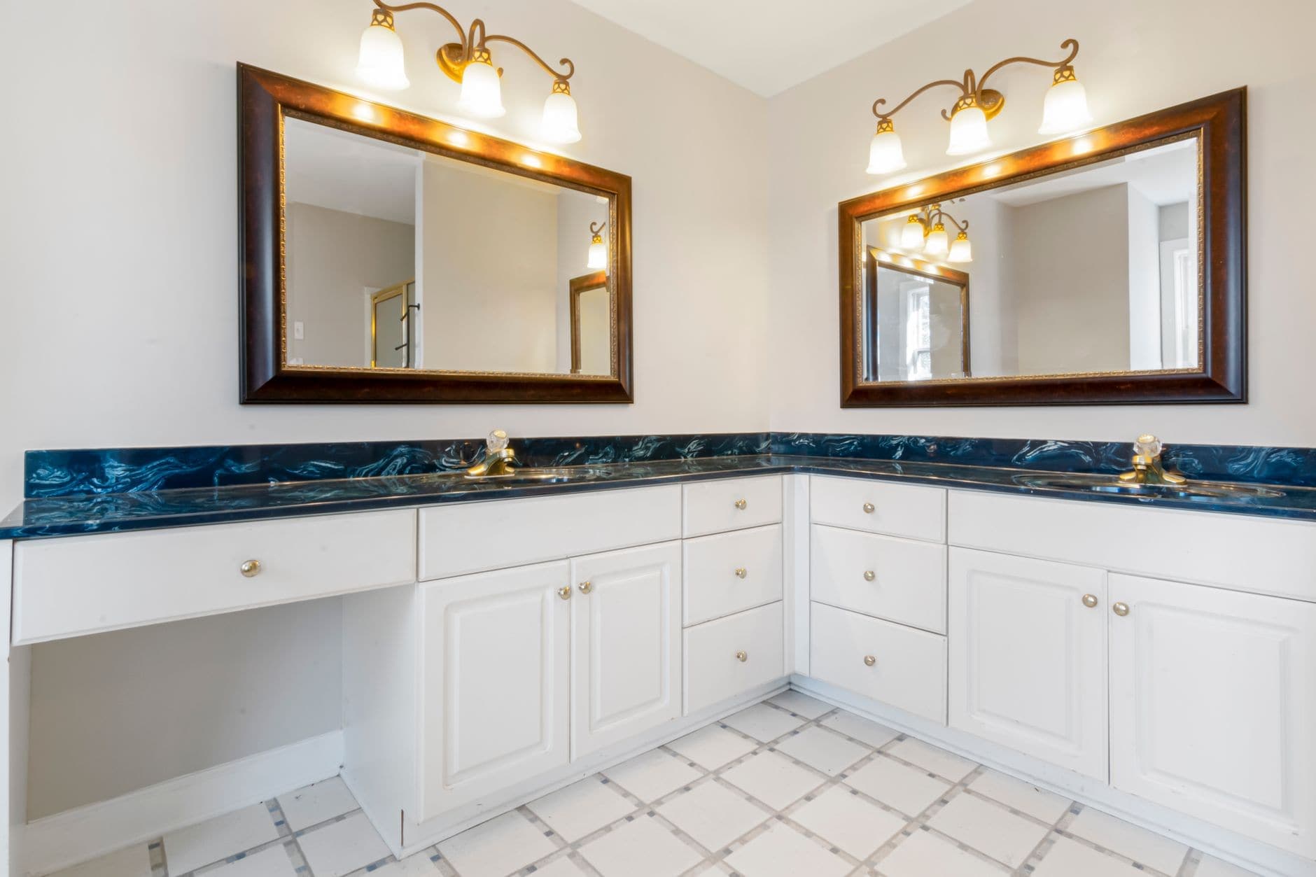 A lit mirror cabinet above a bathroom vanity