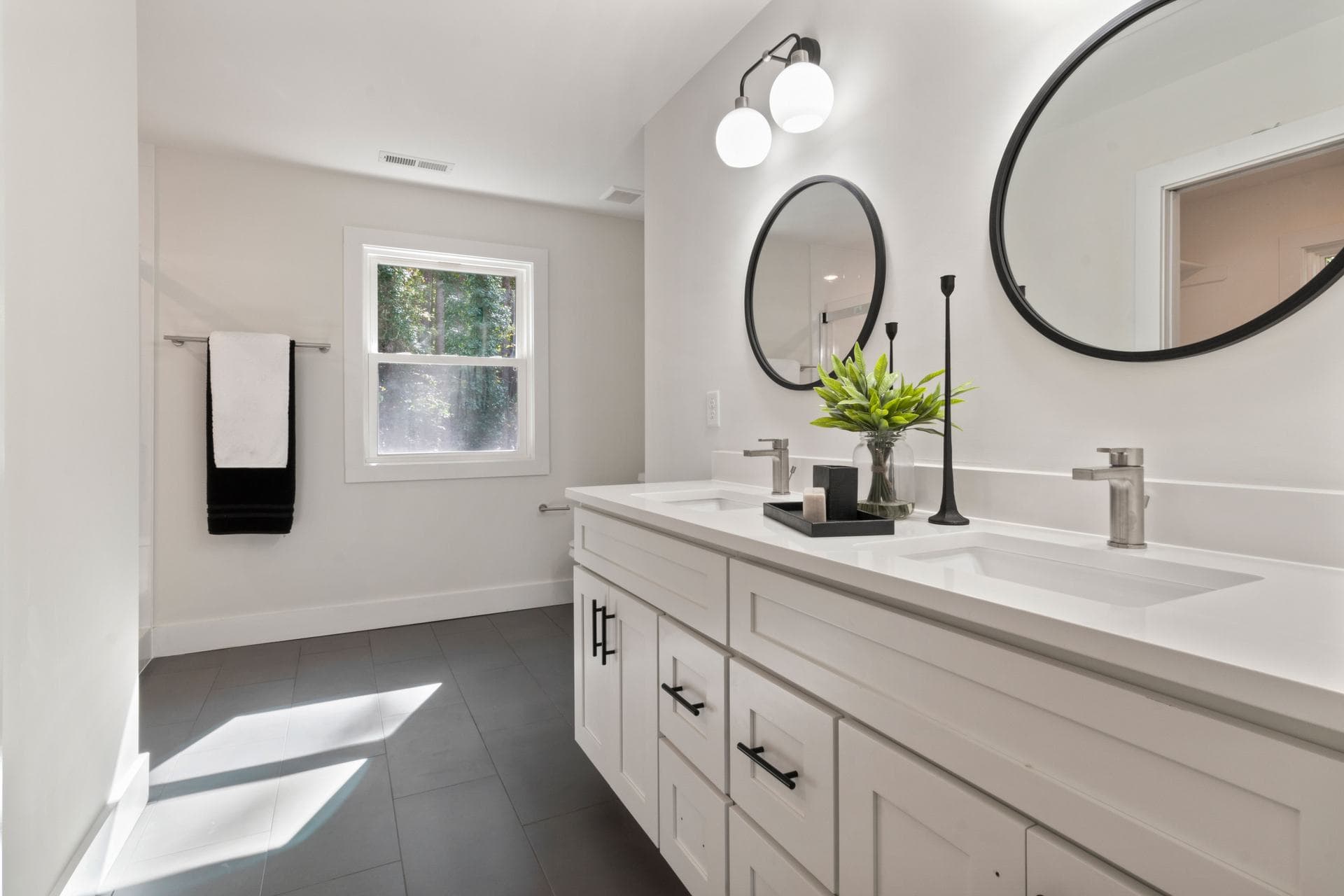A round vanity mirror on a bathroom counter