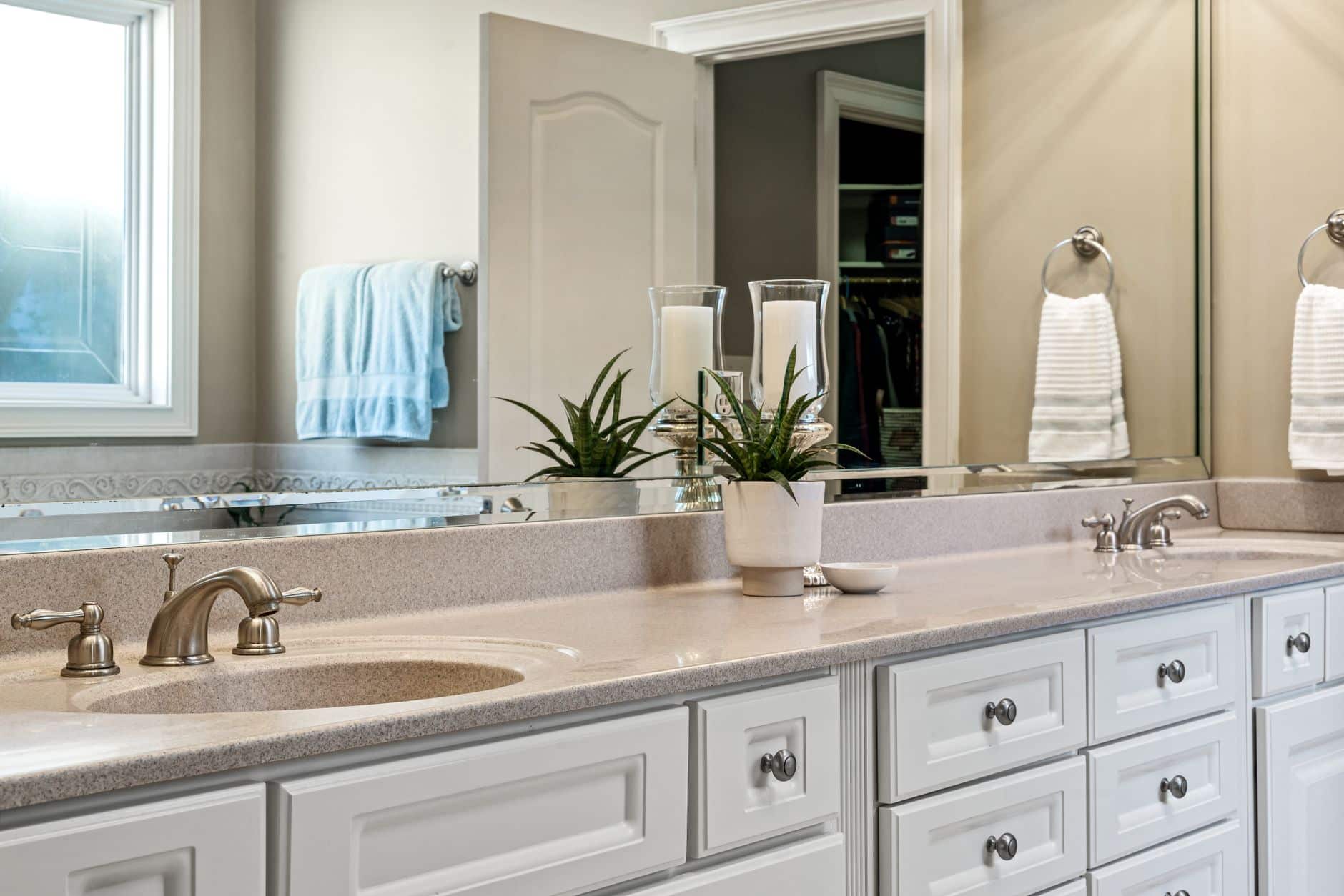 A lighted makeup mirror on a bathroom counter