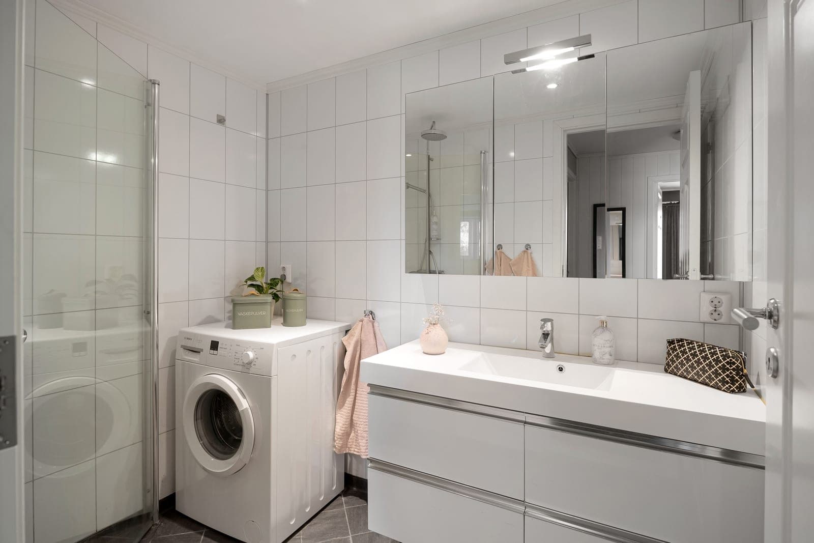 A bright apartment bathroom with a mirror