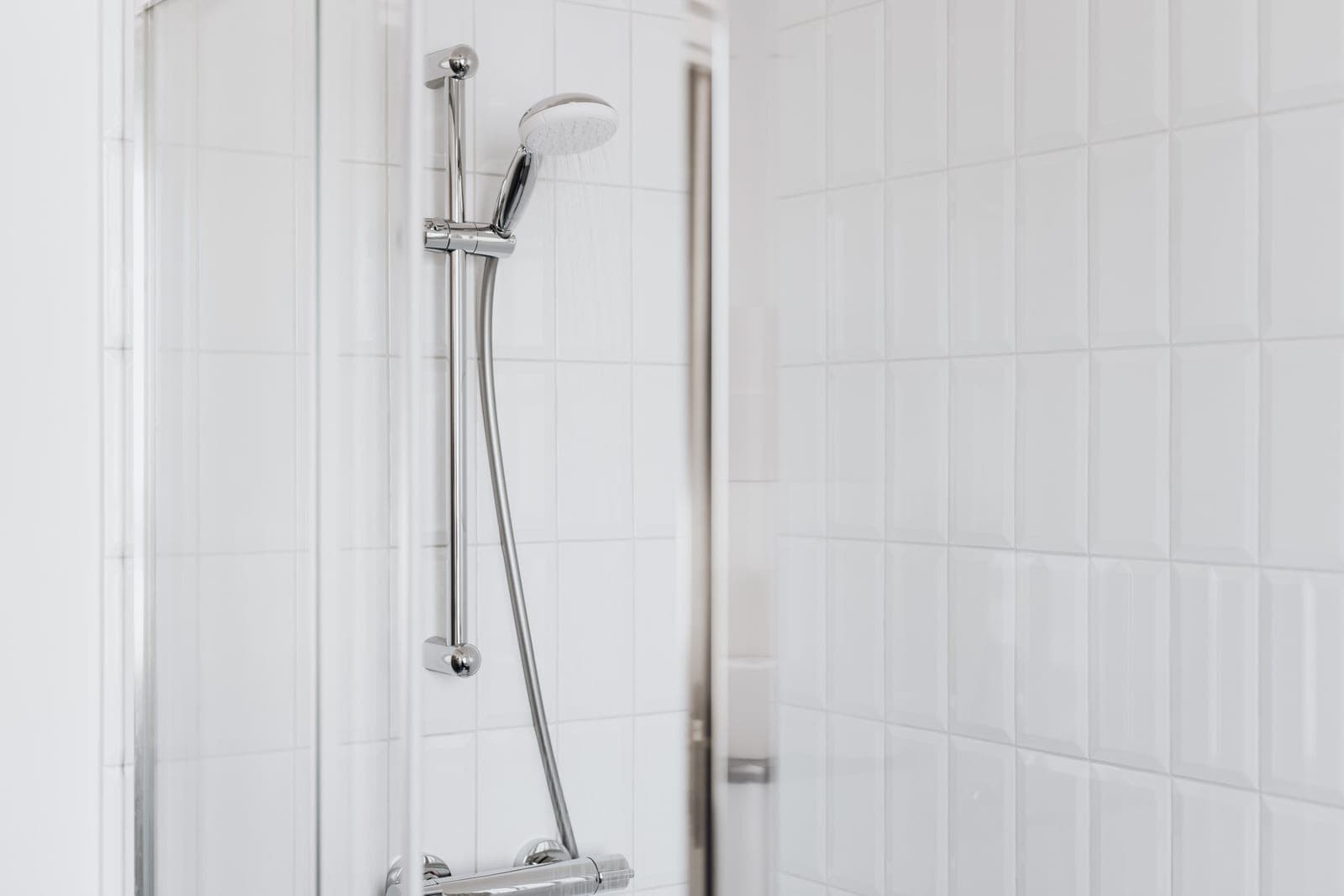 A modern shower with water falling in a tiled enclosure