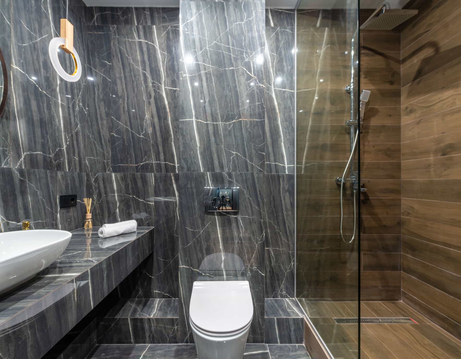 A tall shower panel system on a tiled wall