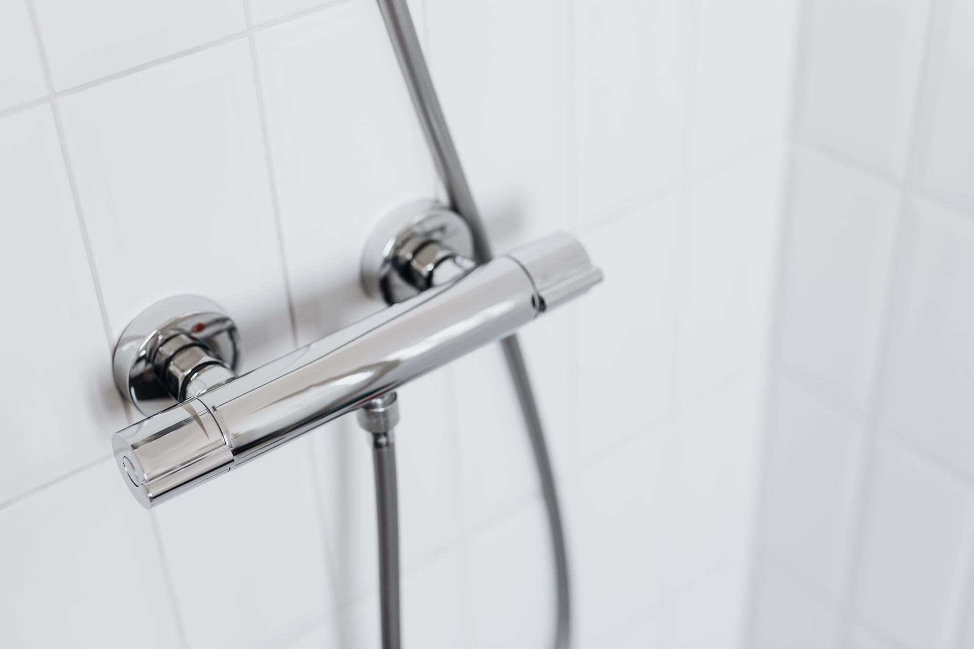 A chrome shower mixer valve control