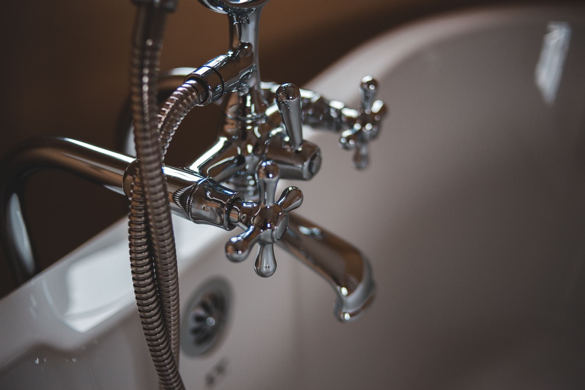 A chrome spout over a bathtub