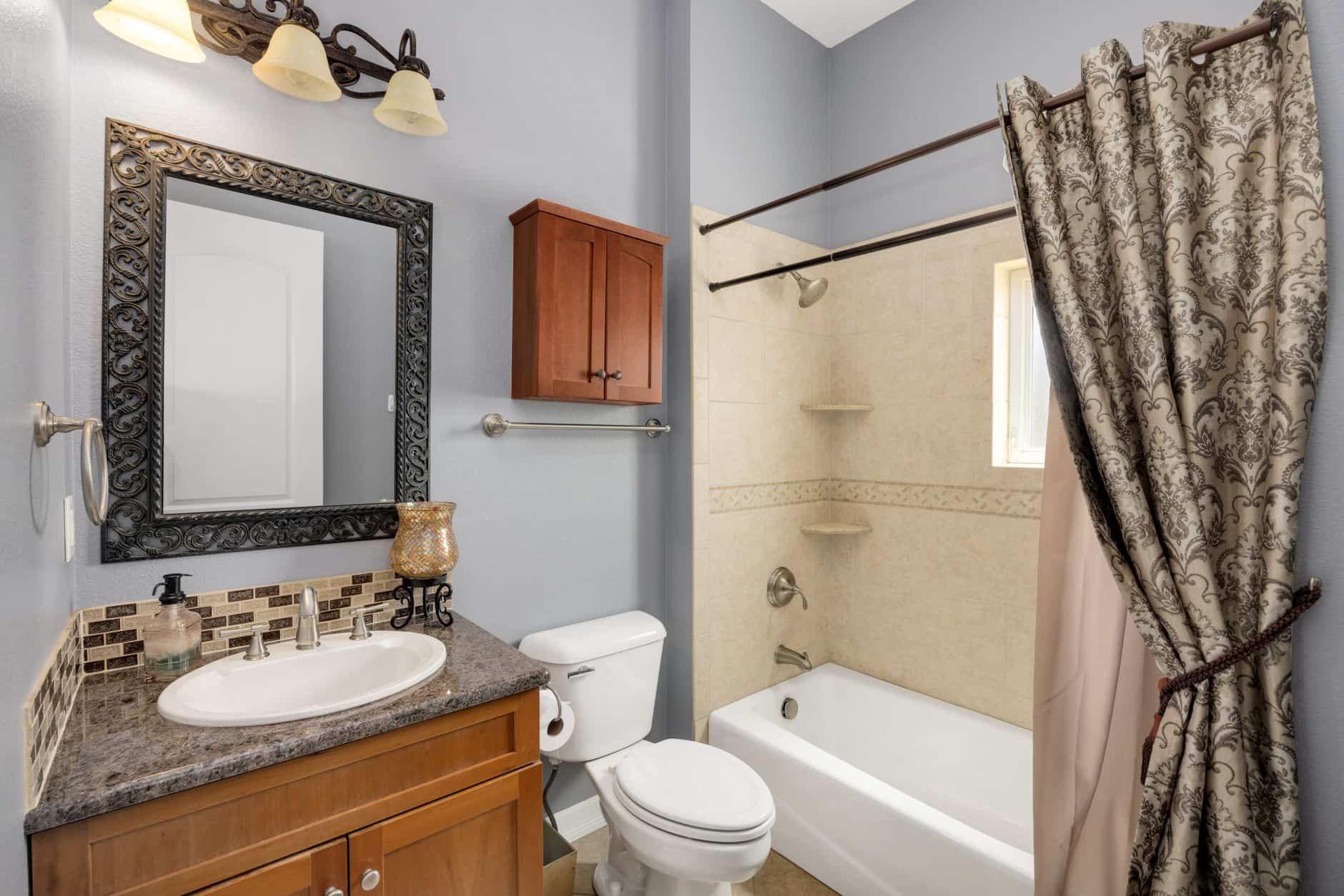 A cotton shower curtain beside a bathtub