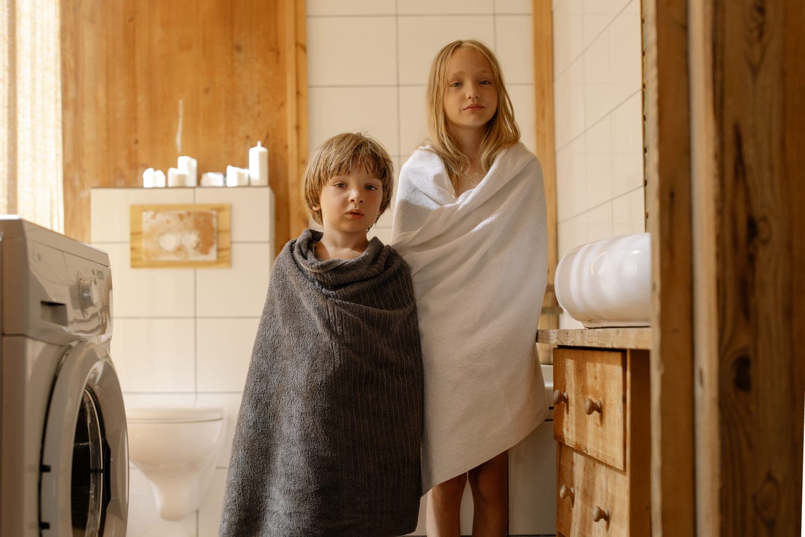 A person wrapped in a warm towel in a bathroom