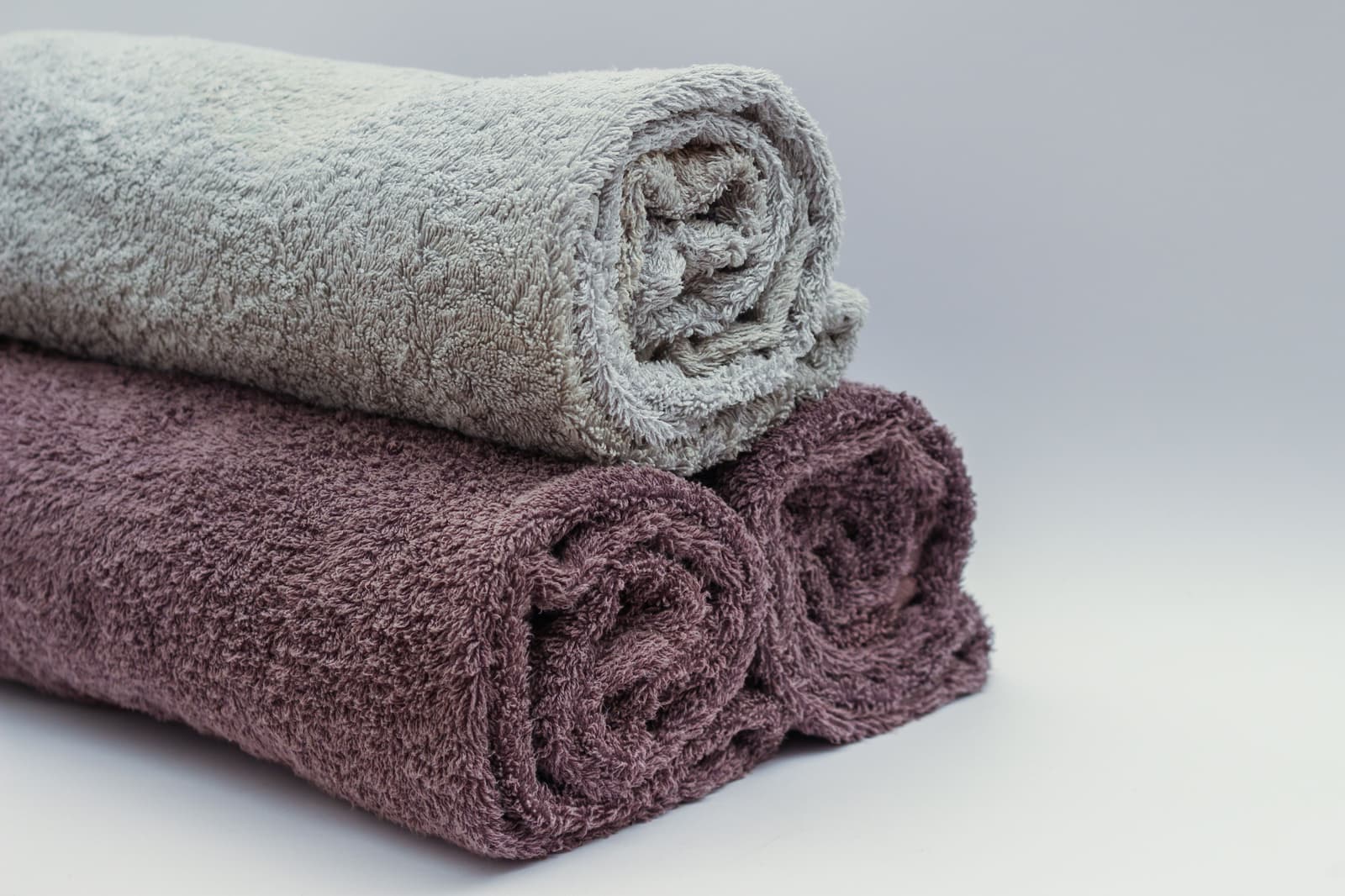 Warm folded towels on a heated rail in a bathroom