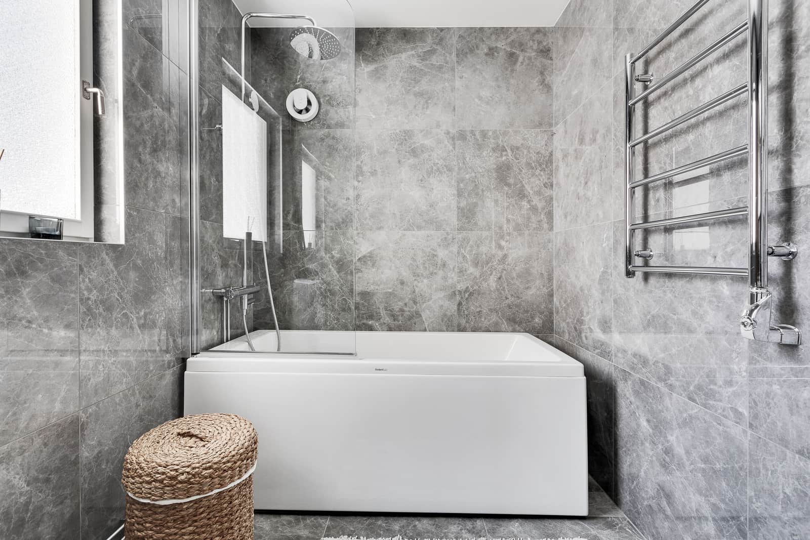 Towels on a rail and towels in a basket in a bathroom
