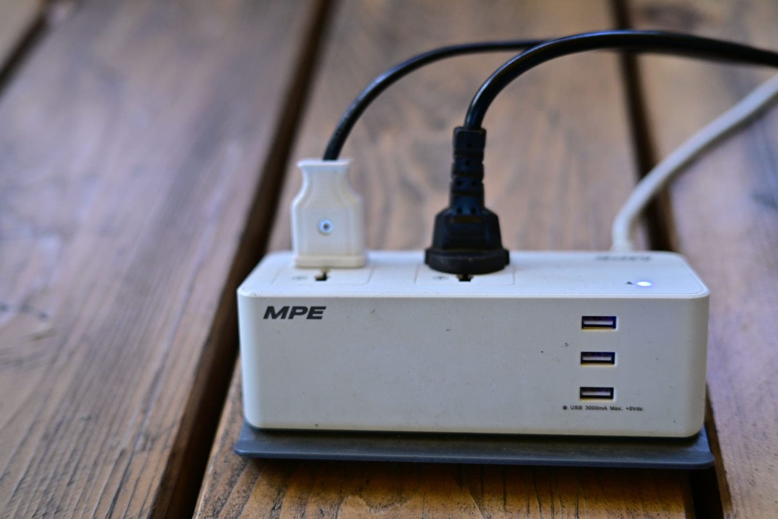 An electrical plug and cable on a floor