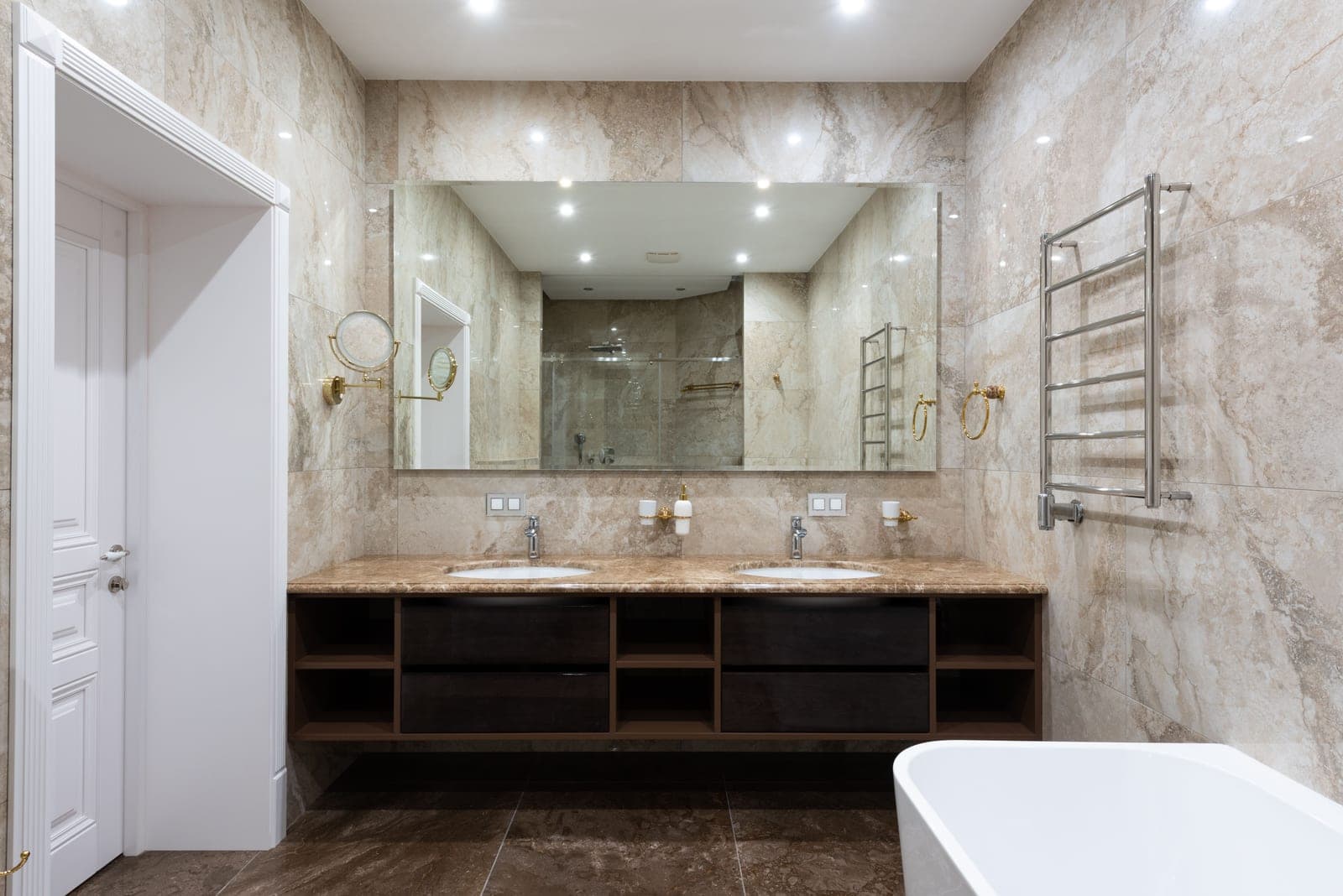 A towel warmer rail holding a white towel